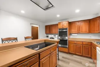 Plenty of counter space, double ovens, stainless steel appliances and overhead vent for stovetop range.