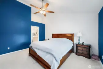 Primary bedroom with view into bath.