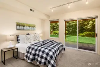 The larger of the two lower-level bedrooms is light and bright with a double-paned glass slider to the backyard.