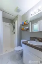 Primary bathroom with tile flooring.