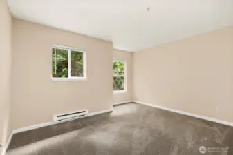 Primary bedroom sits at back of condo, making it a quiet retreat with green views.