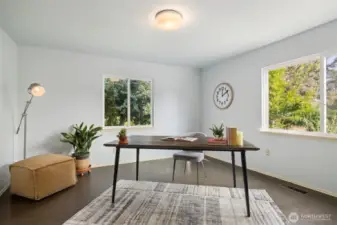 Main level bedroom with lots of windows and views of the gardens.