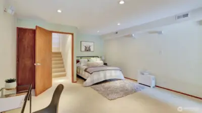 This guest room features soft carpeting and a cozy, welcoming feel.