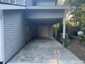 Covered Carport adjacent to Shop Entrance.
