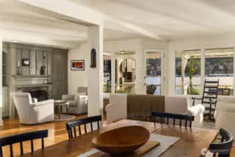 View from the dining room into living room with the water and views just beyond