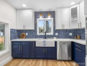 Custom tile backsplash, slide out spice rack, lazy susan, and slide outs for the garbage and recycling make this kitchen super functional