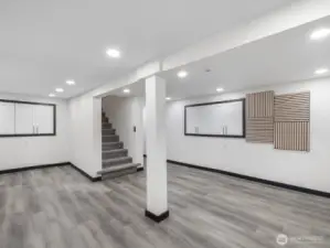 Another view of the fully finished basement with built in cabinetry