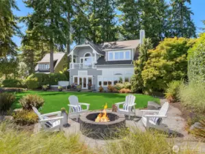 Elevated above the shoreline at the end of a quiet lane, this elegant high-bank waterfront home offers sweeping views, sun-filled outdoor living, and peaceful privacy - an exceptional Bainbridge Island retreat.