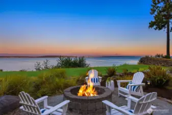 Firepit seating area overlooking the water - an ideal setting for enjoying sunset views and evening gatherings. With Seattle skyline views & Mt. Rainier.