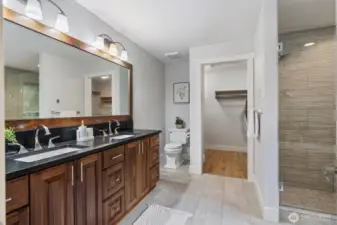 Primary bedroom 5 piece en-suite bathroom with heated floors and black quartz countertops