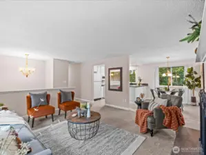 A spacious living room welcomes you with soft natural light and an easy, comfortable layout that invites gathering and relaxation.