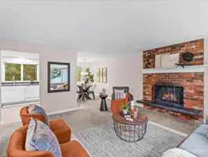 The classic brick fireplace anchors the living room — the perfect place to gather on cool Northwest evenings.