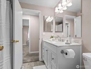 The updated bathroom connects with the primary bedroom for an en-suite experience.