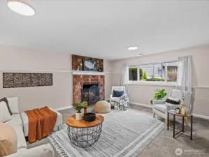 An open floor plan with a large window brings lightness to this rec room.