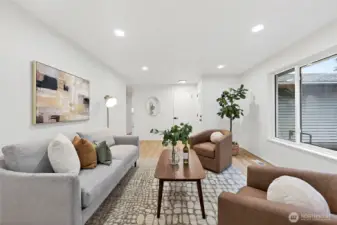 Another angle showcases the living room's spacious layout and neutral palette, with LVP flooring and a clear sightline down the main hallway.