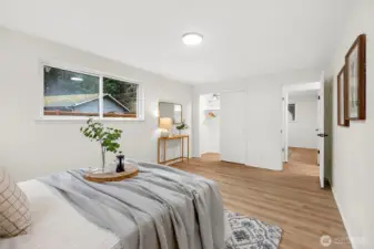 A second angle showcases the primary's generous footprint, dual windows filling the room with natural light, and ample space for a full furniture layout.