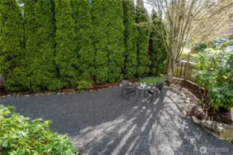 Garden paths and layered vegetation reinforce the feeling of a personal nature preserve.