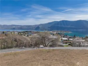 View 4 of homesite looking across road towards views of Lake Chelan and the surrounding mountains.