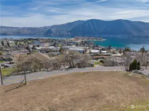 View 3 of homesite looking across road towards views of Lake Chelan and the surrounding mountains.