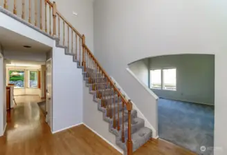 As you enter the home you are greeted by a grand two-story foyer and gleaming hardwood floors.