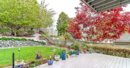 Backyard oasis is fully fenced with garden space and entertainment-sized deck perfect for hosting.
