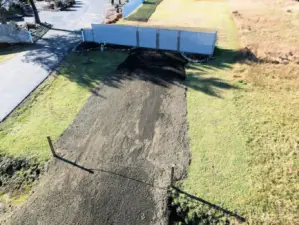 The driveway is in with a gate.