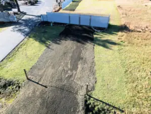 The driveway is in with a gate.