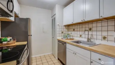 Closet in the kitchen plus cabinets providing plenty of storage space.