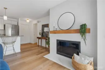 You're welcomed by the warmth of a marble-framed wood-burning fireplace that beautifully anchors the open-concept living, kitchen, and dining areas—creating a cozy and inviting space to gather and unwind.