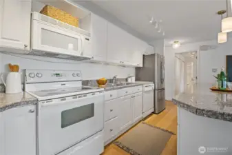 The kitchen boasts timeless white cabinetry, brand-new appliances, and a true chef’s experience—designed for both functionality and style, whether you're whipping up weeknight dinners or entertaining guests.