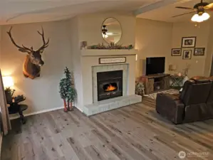 Family room with warm, real wood burning fireplace