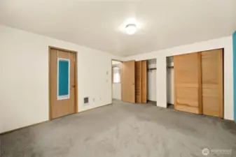 The master bedroom with access to the full bath through the door on the left.  Two large full-sized closets with beautiful wood doors.