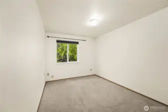 The second guest bedroom has a view of the greenbelt as well.