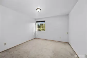 The third bedroom upstairs has a window overlooking the neighborhood.