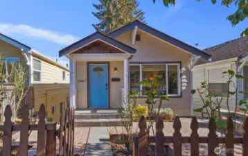 You are welcomed in with a picket fence and rose garden patio.