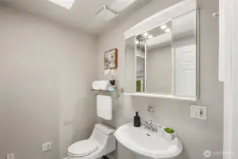 Main floor half bathroom even has its own skylight.