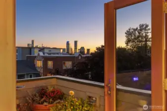 Top floor primary suite with sitting space and rooftop deck