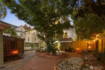 Fully landscaped lush spa like backyard with sauna that conveys with sale