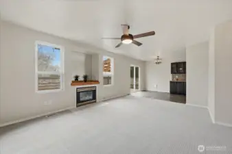 Living room has new carpeting & paint, double windows and gas fireplace