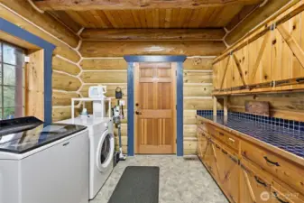Laundry room with huge folding station and cabinetry.
