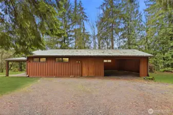 Backyard outbuilding with office, recreation room/shop, covered parking with charges station