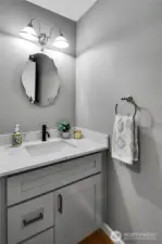 Updated cabinetry and quartz counter on main level powder room.
