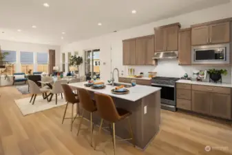 Wonderful Kitchen dining and great room layout from entry.  Photos are for illustrative purposes, actual home is under construction with a Spring 2024 move in