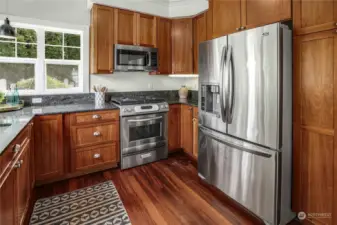 Kitchen with stainless steel appliances, including a propane range.