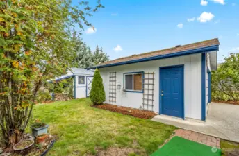 Detached garage with double rool up door and side access.