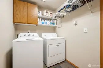 Function without the fluff. You’ve got your included washer, your dryer, slate tile underfoot that laughs in the face of muddy socks, and just enough cabinetry and shelving to keep you organized.