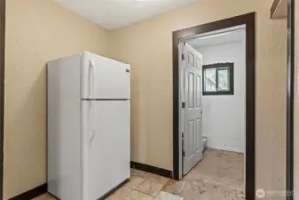 kitchen offers direct access to a spacious laundry room—ready for your finishing touches and perfect for customizing to your needs.