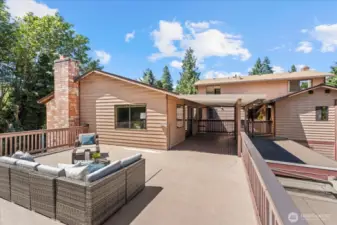 Sun deck looking into covered deck between wings; each has it's own glass door entrance into home; LEFT into that spectacular family bonus room and RIGHT into formal dining & kitchen...