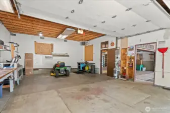 This is the shop/garage where the Celling height is well over 10 feet!!  We  think it is possible to add & have work benches' wrapped all across back and sides and STILL have room parking of 2 huge vehicles/work trucks/vans etc.
