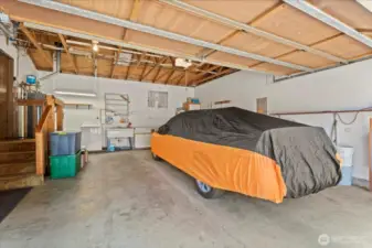 NOW, This 3rd garage is up front with main floor accessed just 4 steps from slab. oversize 2-car makes a total of 8 covered spots for your collection. Double deep utility sink and Laundry space and high open rafters makes for more spots to stash your storage